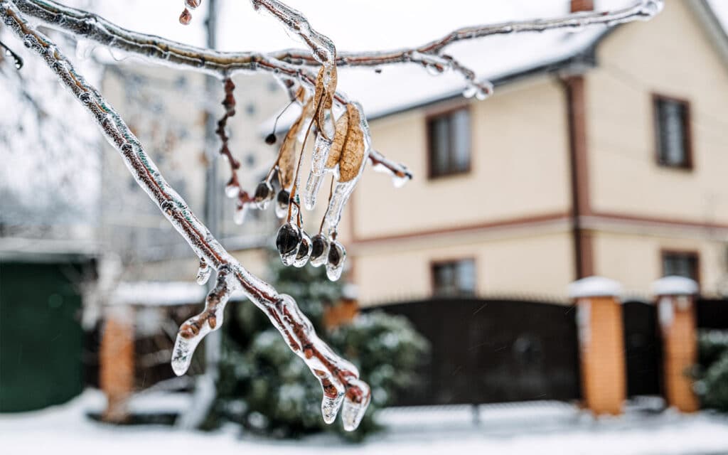 Memphis house covered in ice after a winter storm at risk of frozen pipes.